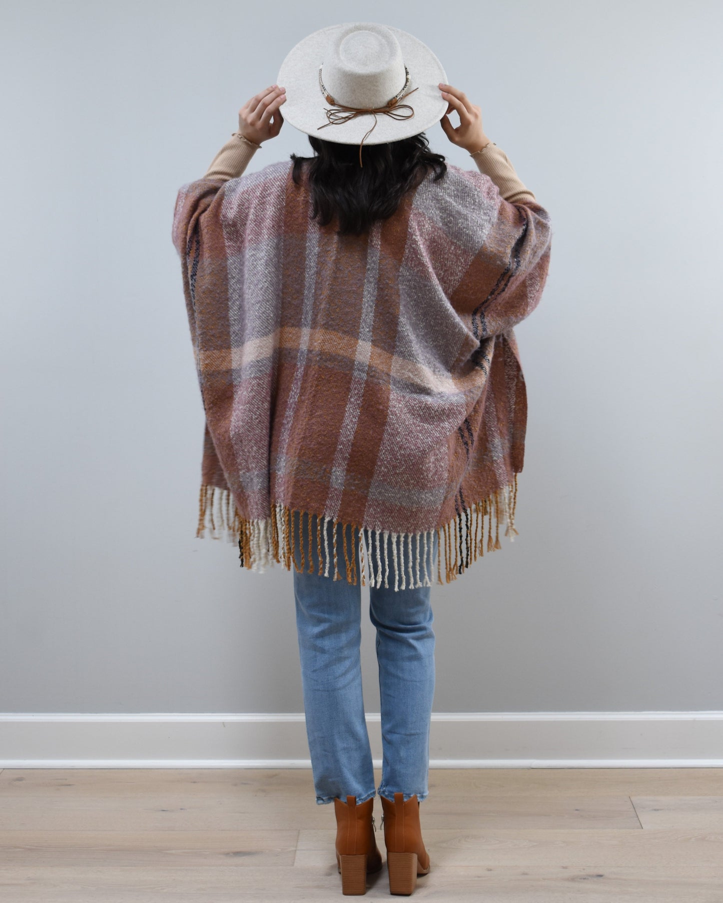 Mauve Meadow Ruana on soft linen background, featuring brushed knit texture and mauve-neutral stripes.