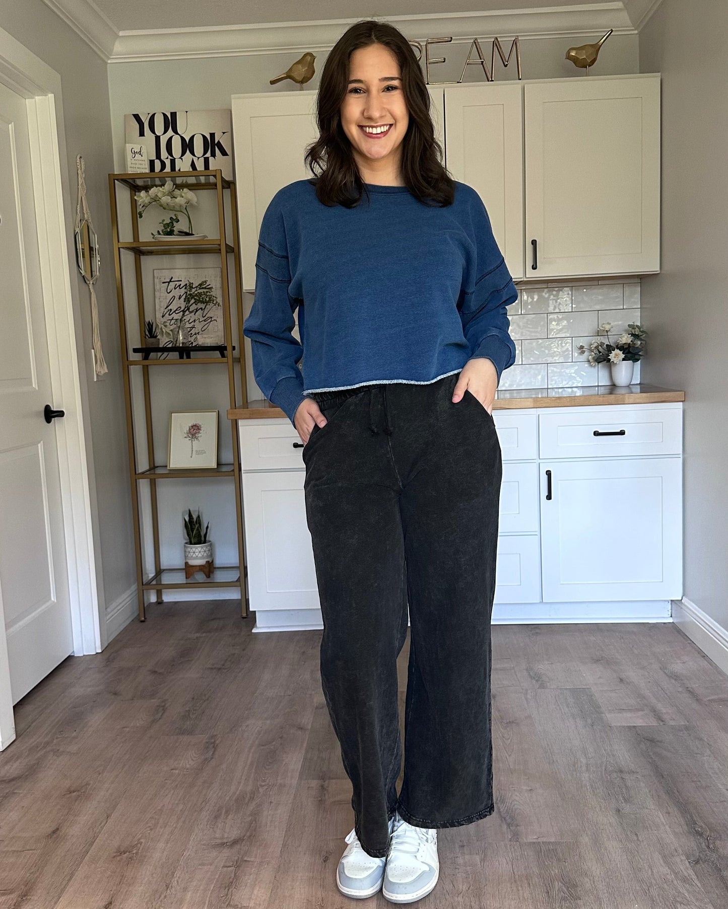 Oversized denim-wash sweatshirt layered over a tank for casual wear