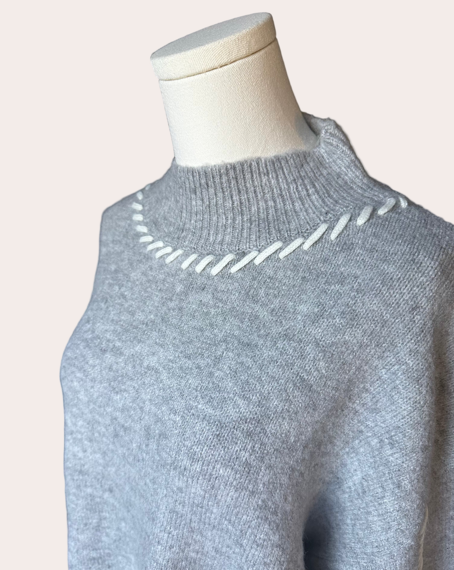 Heather grey crew-neck sweater with soft contrast stitching along the neckline and sleeves, midweight knit with stretch, photographed on a Soft Linen background for Justyna Grace Boutique.