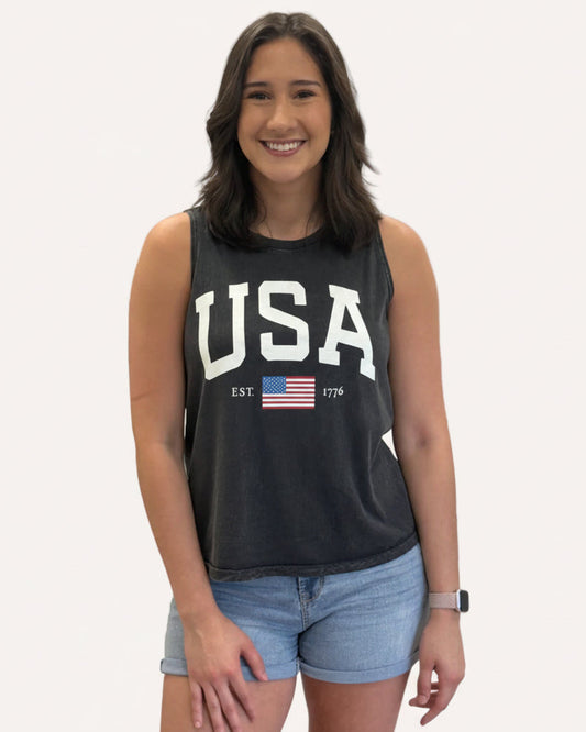 Vintage black mineral-wash “USA EST. 1776” graphic tank in soft cotton with relaxed fit and patriotic design.
