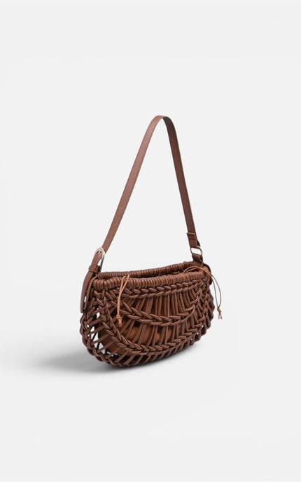 Textured, crescent-shaped woven vegan leather clutch with braided detailing, a structured base, and an adjustable shoulder strap.