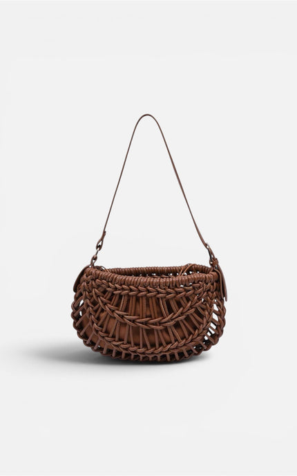 An elevated, everyday crescent clutch made from woven vegan leather, featuring a comfortable adjustable strap and a secure inner pouch for essentials.