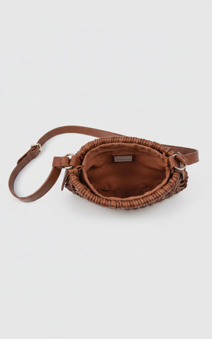 Close-up view of the clutch interior showcasing the integrated fabric drawstring pouch designed for secure storage.