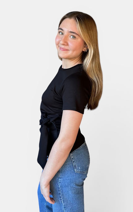 Side view of women's black modal knot top with relaxed fit.