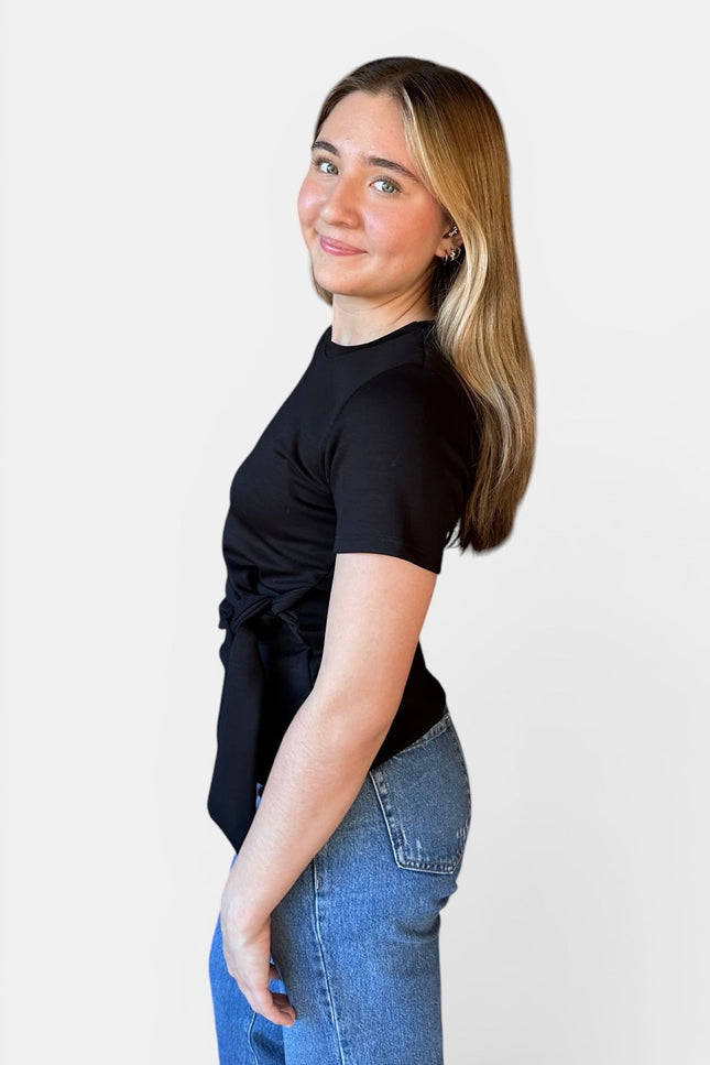 Side view of women's black modal knot top with relaxed fit.