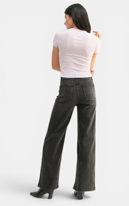 Side view of high-rise black wide-leg jeans with a relaxed full-length fit.