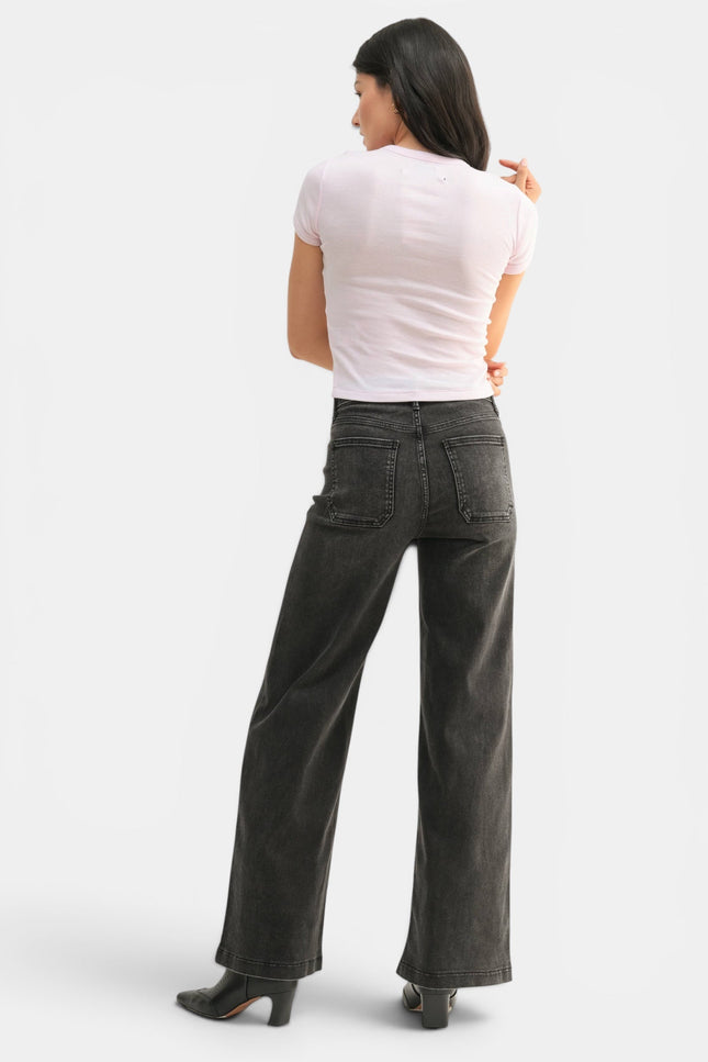 Side view of high-rise black wide-leg jeans with a relaxed full-length fit.