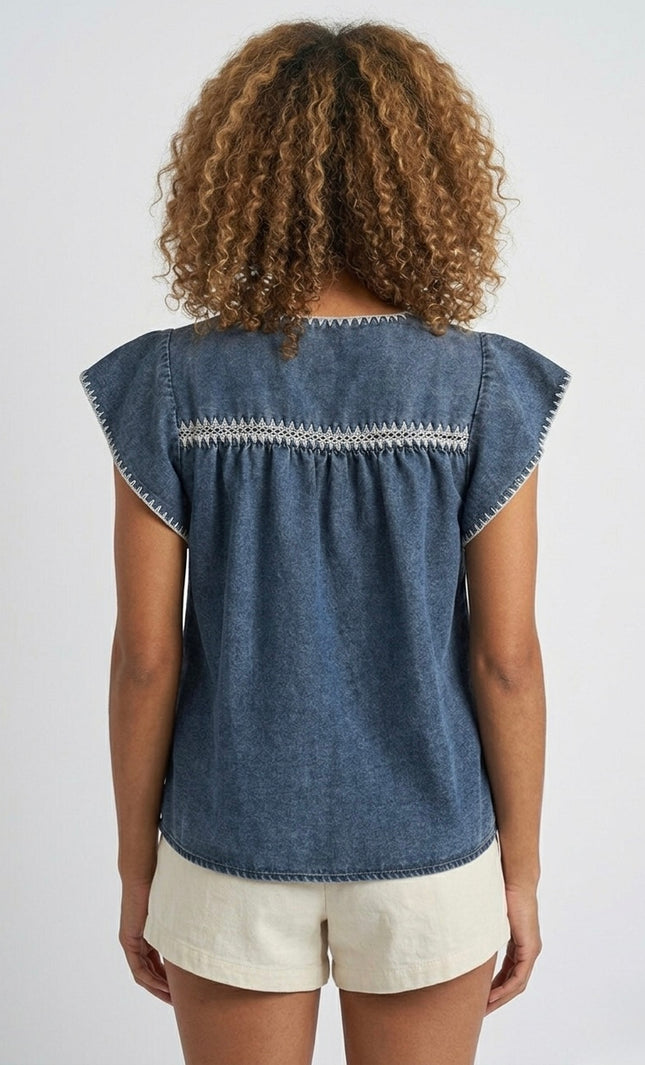 Back view of women's indigo embroidered denim top.