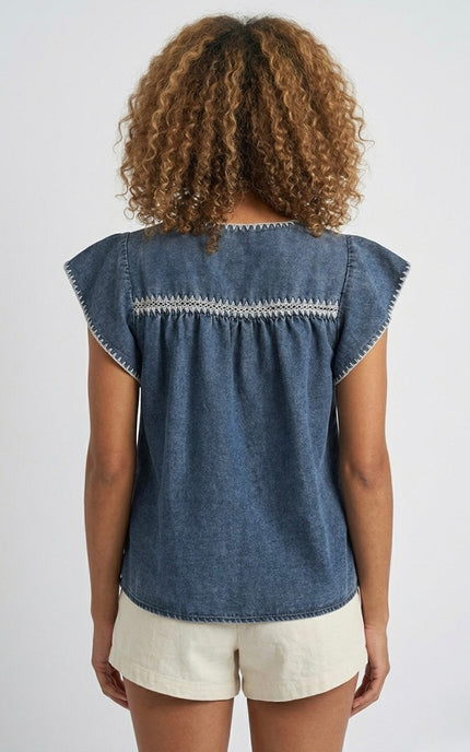 Back view of women's indigo embroidered denim top.