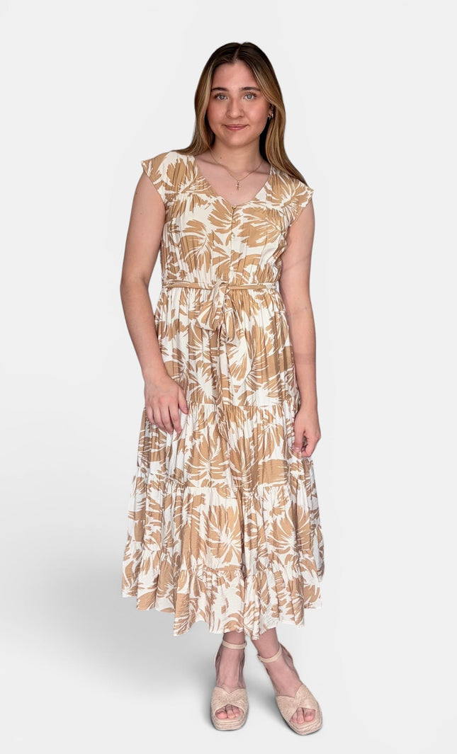 Sleeveless midi dress with a beige and white botanical leaf pattern, standing against a light gray studio background.