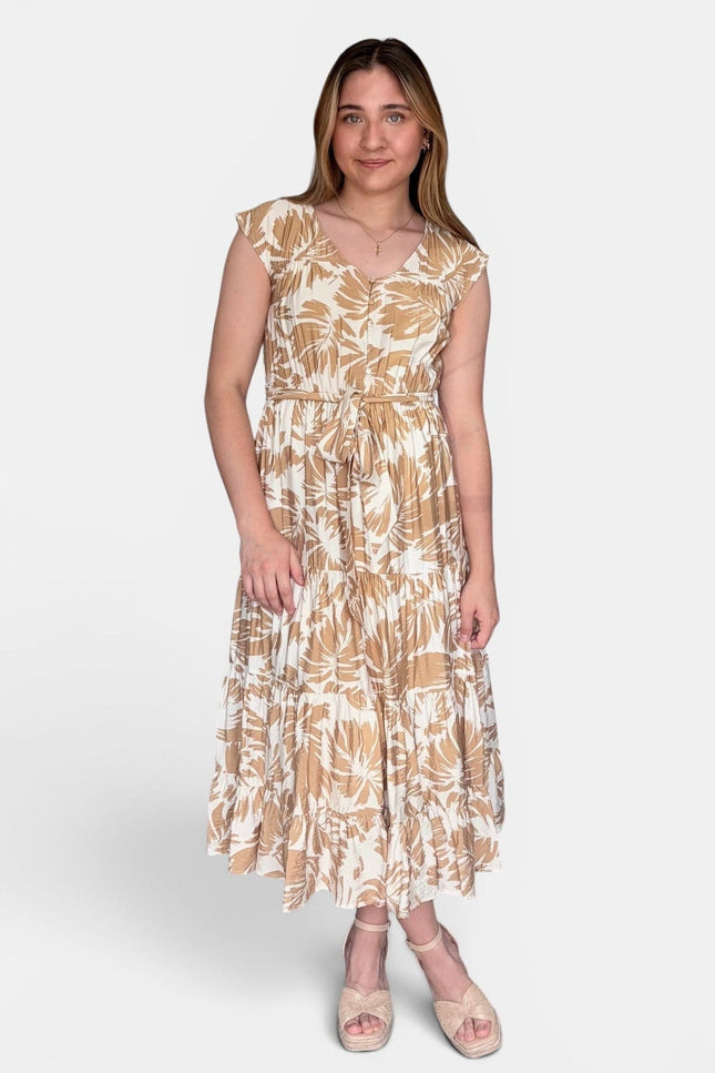 Sleeveless midi dress with a beige and white botanical leaf pattern, standing against a light gray studio background.