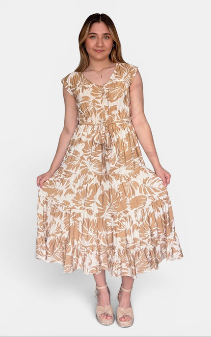 Sleeveless midi dress with a beige and white tropical leaf pattern, standing against a light gray studio background.