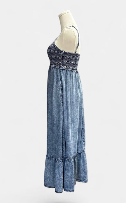 Side view of a sleeveless tiered midi dress made from soft, breathable Tencel.