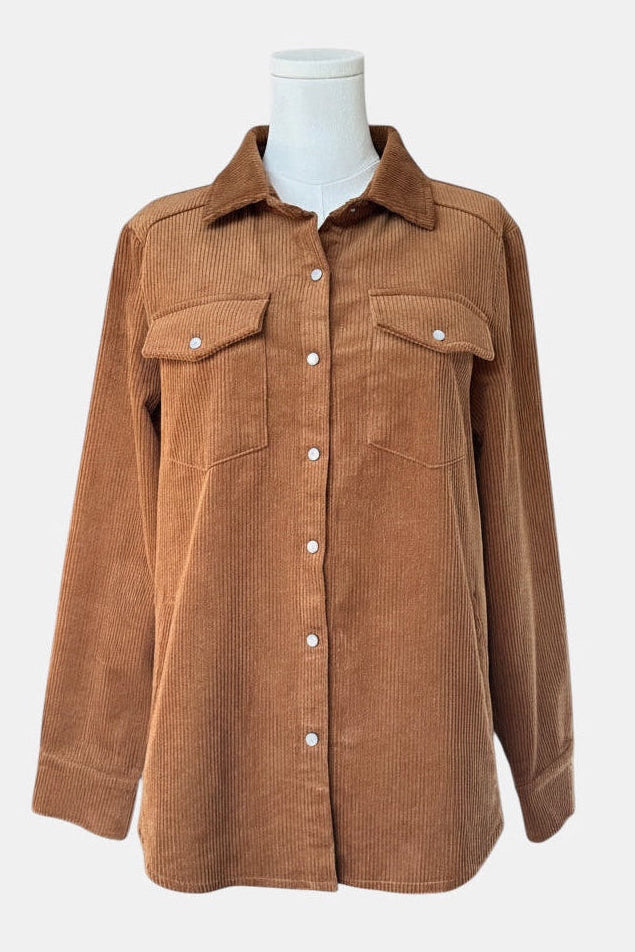 A brown corduroy button-up shirt jacket with two chest flap pockets, displayed on a white mannequin torso against a light gray background.