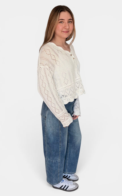 Sheer crochet sweater layered over a tank top
