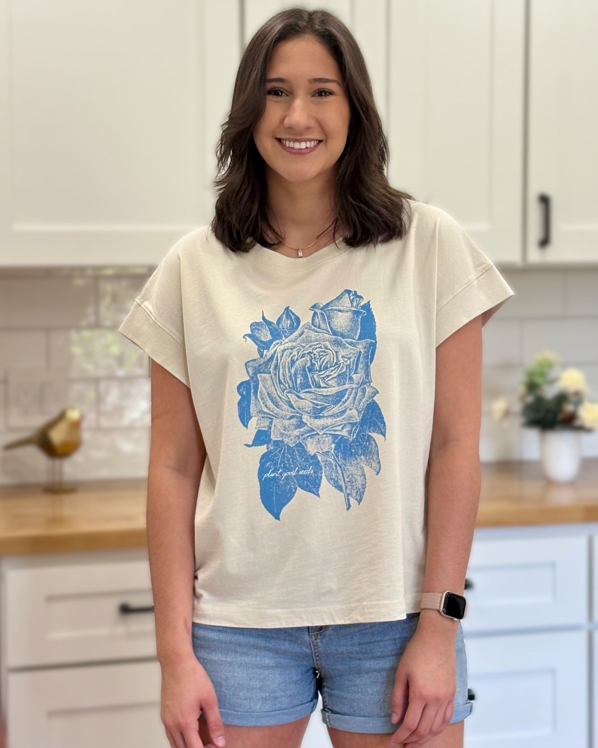 Cream graphic tee with blue faith-inspired design, ethically made and styled for a relaxed fit.