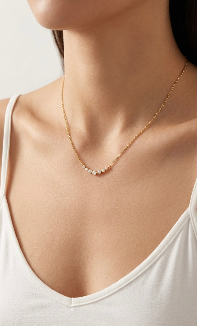Side view of the necklace on the neck showing the slim chain and lightweight drape.