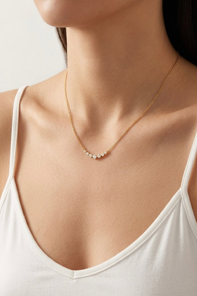 Side view of the necklace on the neck showing the slim chain and lightweight drape.