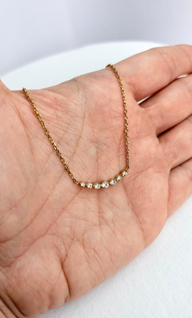Zircon bar necklace resting in an open palm, showing delicate scale and subtle sparkle.