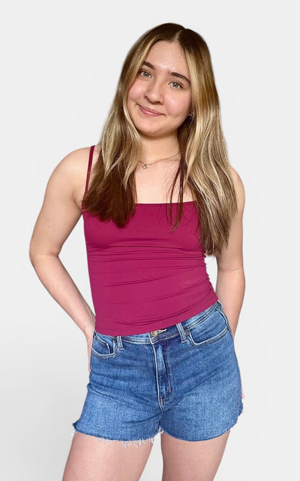 Comfortable medium-wash jean shorts with a raw hem and soft stretch for everyday wear.