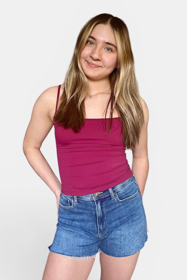 Comfortable medium-wash jean shorts with a raw hem and soft stretch for everyday wear.