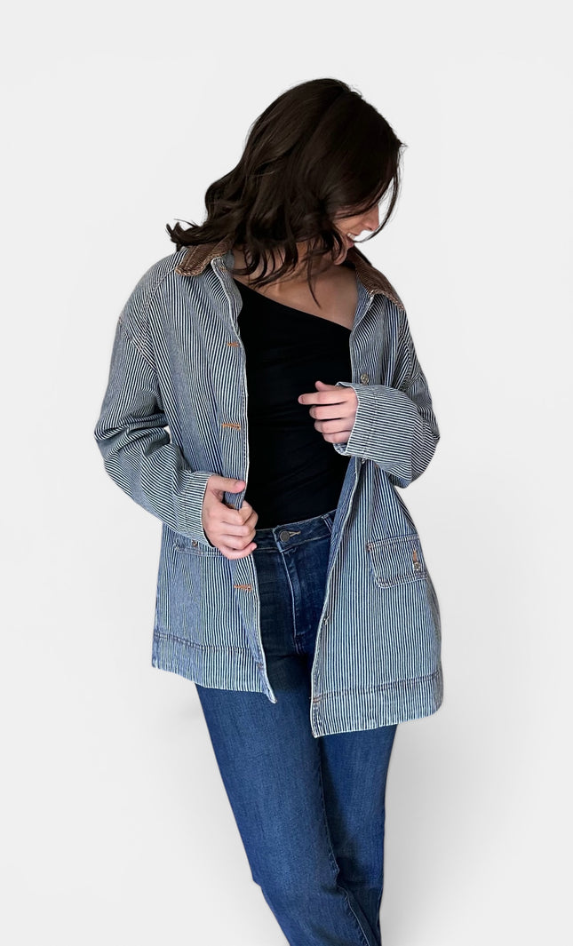 Front view of women's denim barn coat with corduroy collar.