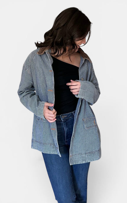 Front view of women's denim barn coat with corduroy collar.