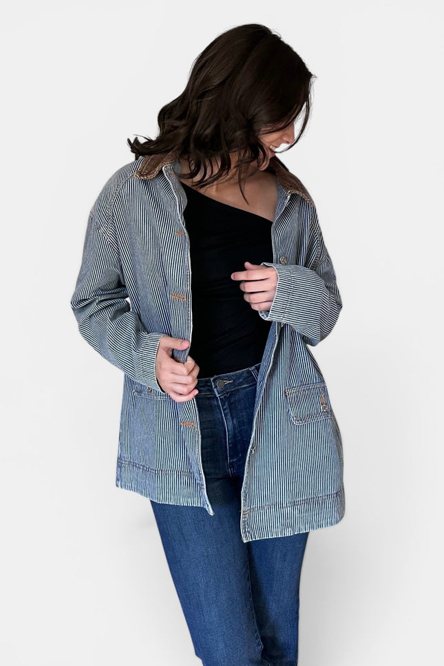 Front view of women's denim barn coat with corduroy collar.
