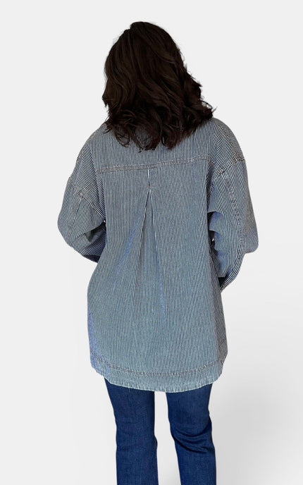 Back view of women's denim barn coat with relaxed silhouette.