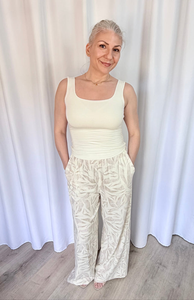 Model wearing island leaf print straight leg pants with hands in pockets, showcasing the relaxed fit and breezy rayon linen fabric.