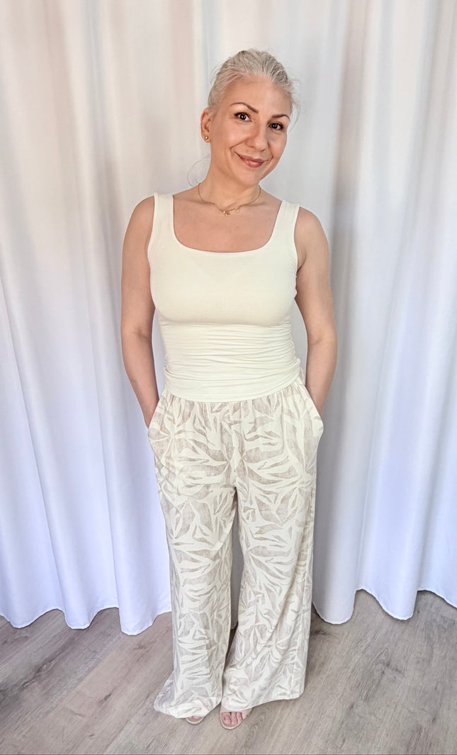 Model wearing island leaf print straight leg pants with hands in pockets, showcasing the relaxed fit and breezy rayon linen fabric.