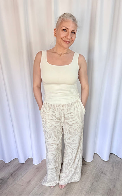 Model wearing island leaf print straight leg pants with hands in pockets, showcasing the relaxed fit and breezy rayon linen fabric.