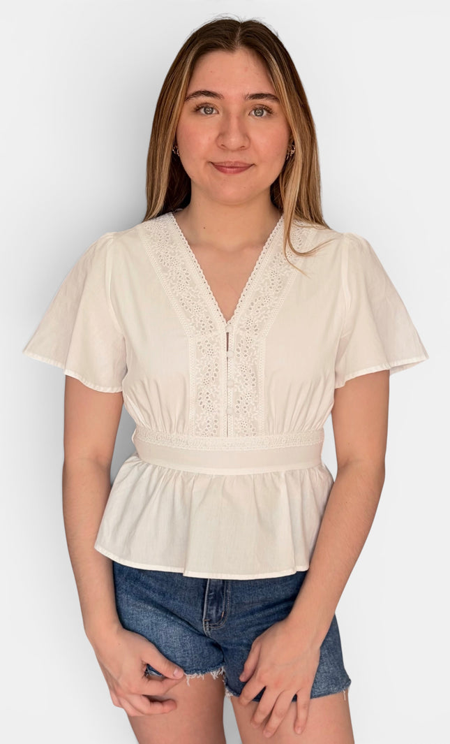 White eyelet cotton blouse with V-neck and button front