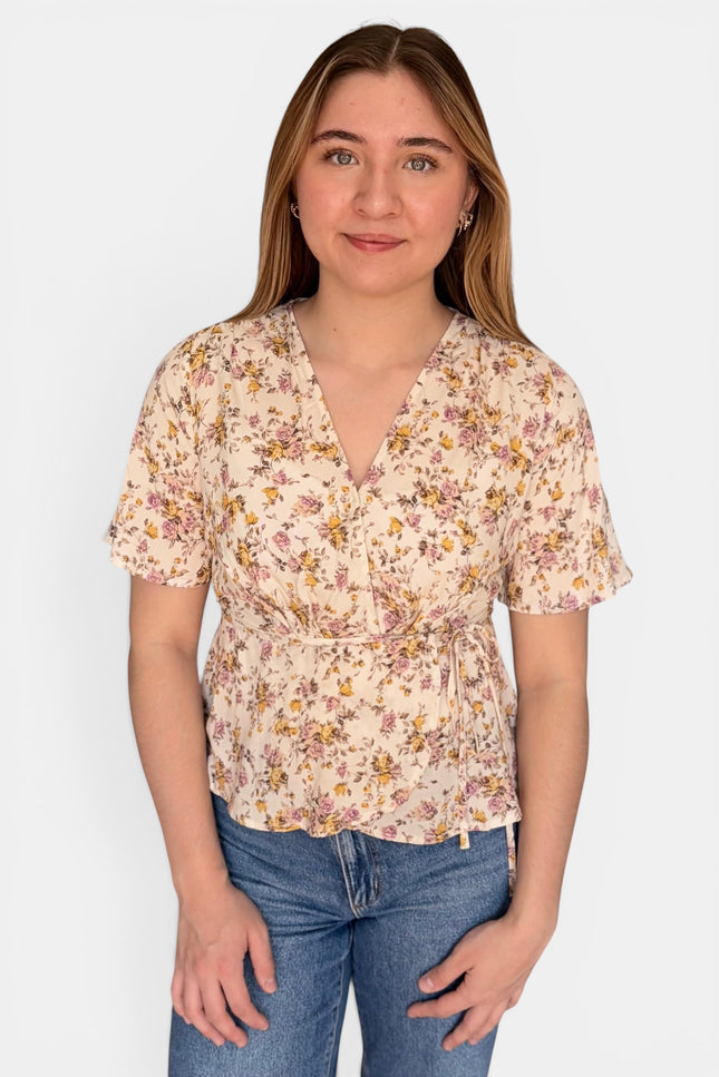 Floral wrap blouse in lightweight 100% rayon with a waist tie and flattering V-neckline.