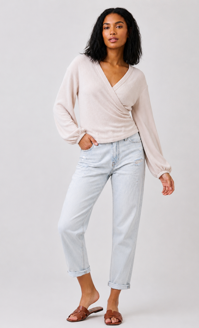 Women's long sleeve ribbed knit surplice top with side shirring.