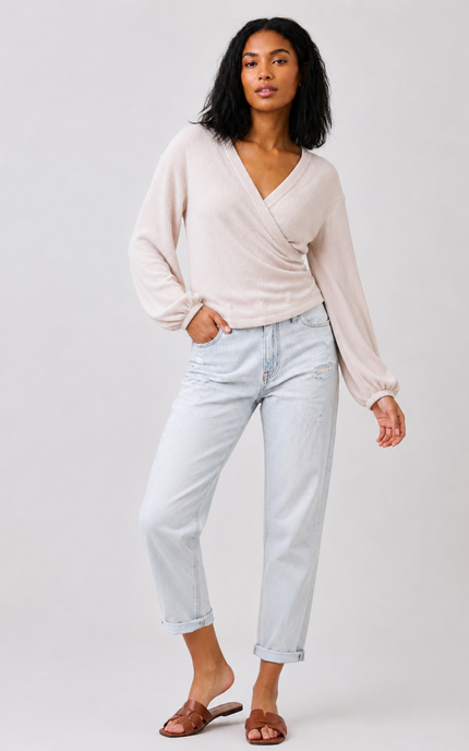 Women's long sleeve ribbed knit surplice top with side shirring.