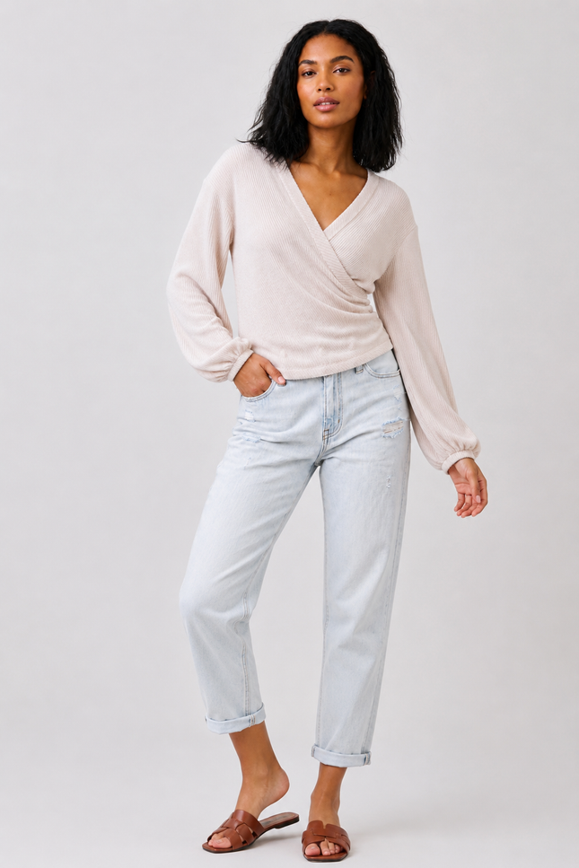Women's long sleeve ribbed knit surplice top with side shirring.