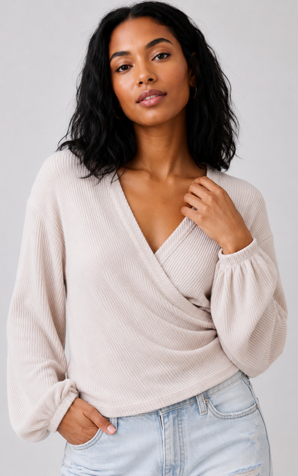 Close-up of surplice neckline and ribbed knit texture.