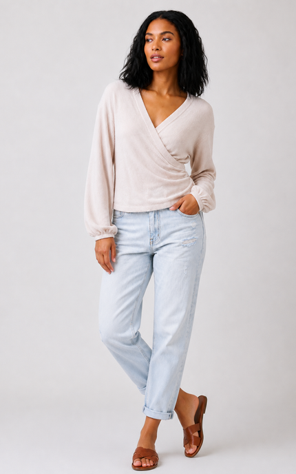 Surplice neckline and ribbed knit texture.