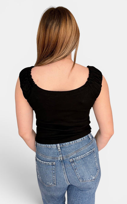 Back view of black fitted ribbed tank with scoop neckline, ruched straps, and soft cotton-spandex stretch