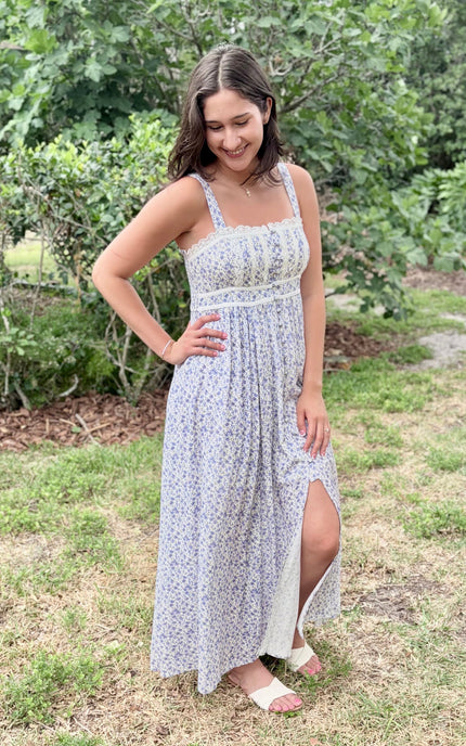 Side profile of the floral maxi dress highlighting the contrasted piping and flowing skirt.