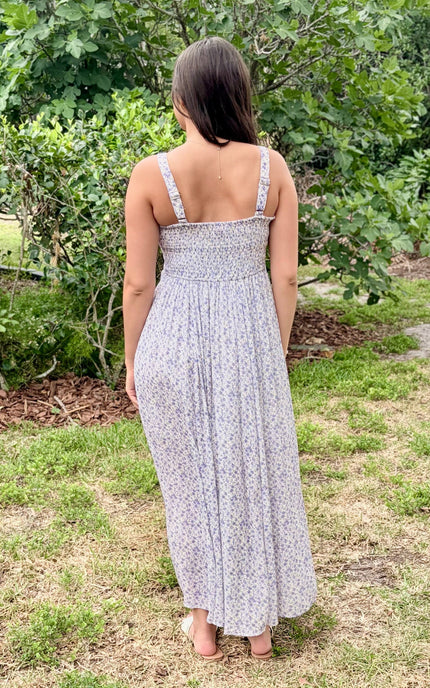 Back view on model highlighting smocked panel and adjustable straps.