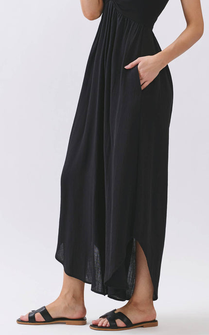 Woman wearing a black halter neck dress on a white background