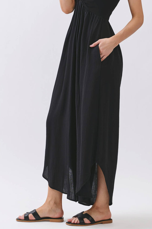Woman wearing a black halter neck dress on a white background