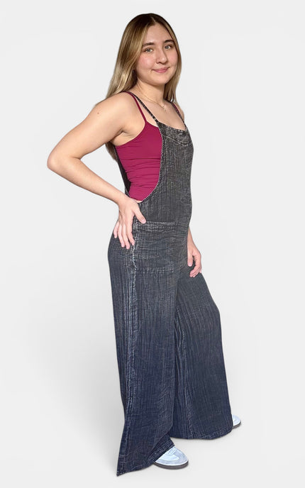 Casual black sleeveless jumpsuit with a loose wide leg silhouette styled for warm weather.