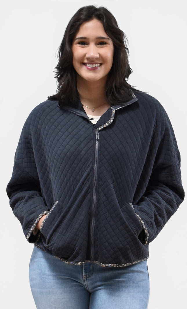 Front view of women's quilted zip-up jacket with floral contrast accents.