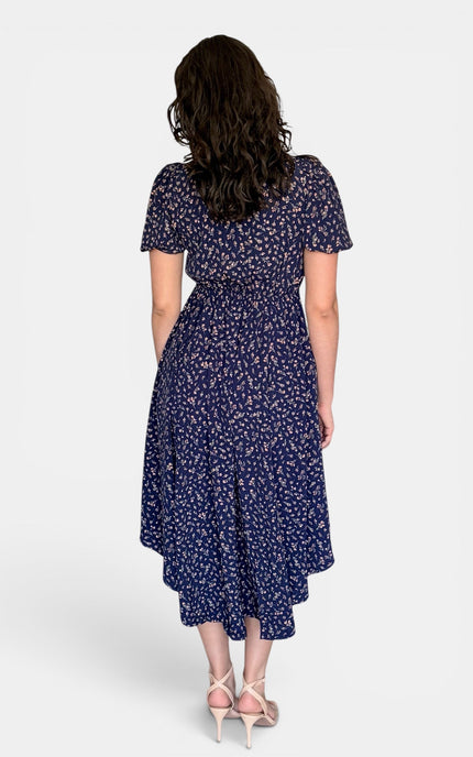  Modest floral midi dress with puff sleeves, V-neckline, and elegant everyday styling.
