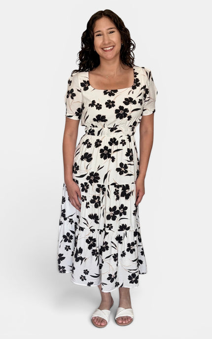 Tiered skirt detail on floral midi dress with flowy silhouette