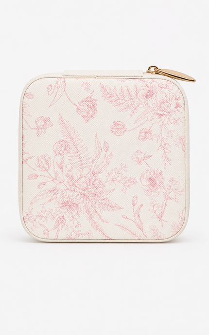 A square zippered pouch with rounded corners, featuring a light pink botanical line-art pattern on a warm off-white background, finished with a gold-tone zipper pull.