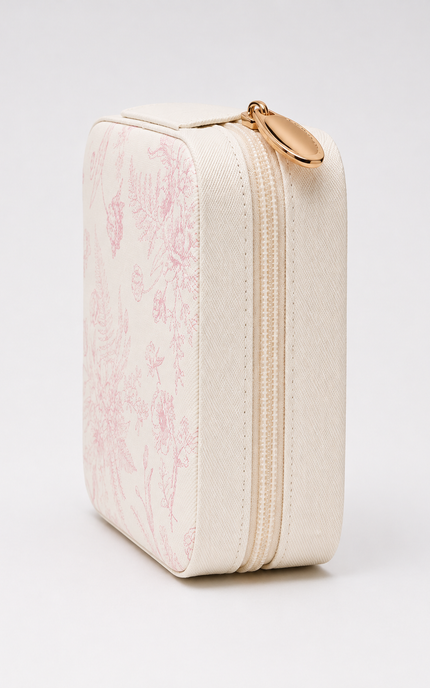 A cream-colored rectangular zippered pouch featuring a light pink toile de Jouy pattern on the front, with a gold-tone metal zipper pull, shown on a clean white background.